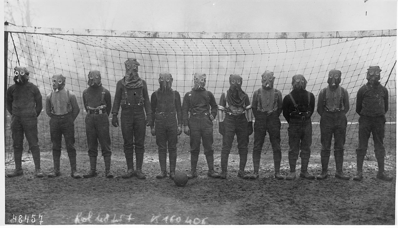 1280px-World_War_I,_British_soccer_team_with_gas_masks,_1916